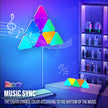 Color-changing LED triangle lights synced to music in a room with shelves and a guitar.