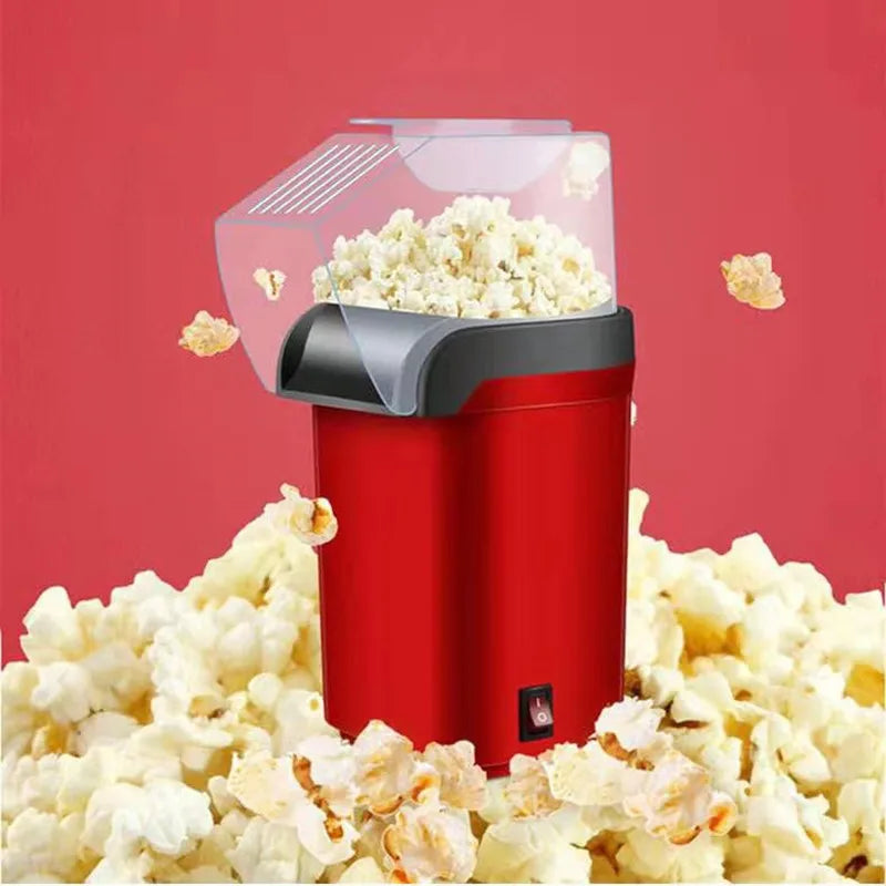 Red popcorn maker with popped popcorn against a red background