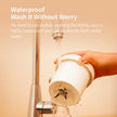 Person washing a white bottle under running water with text about the bottle's waterproof feature.
