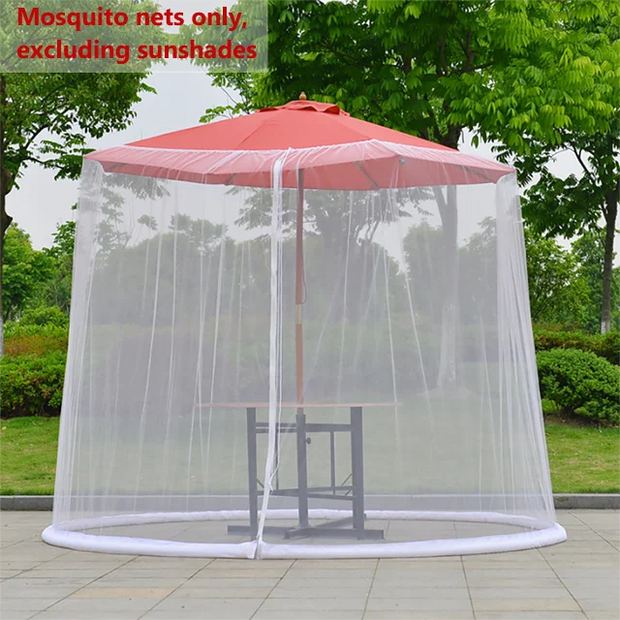 Mosquito net around a red outdoor umbrella with greenery in the background