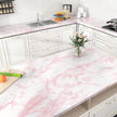 Kitchen with pink marble countertops and white cabinets