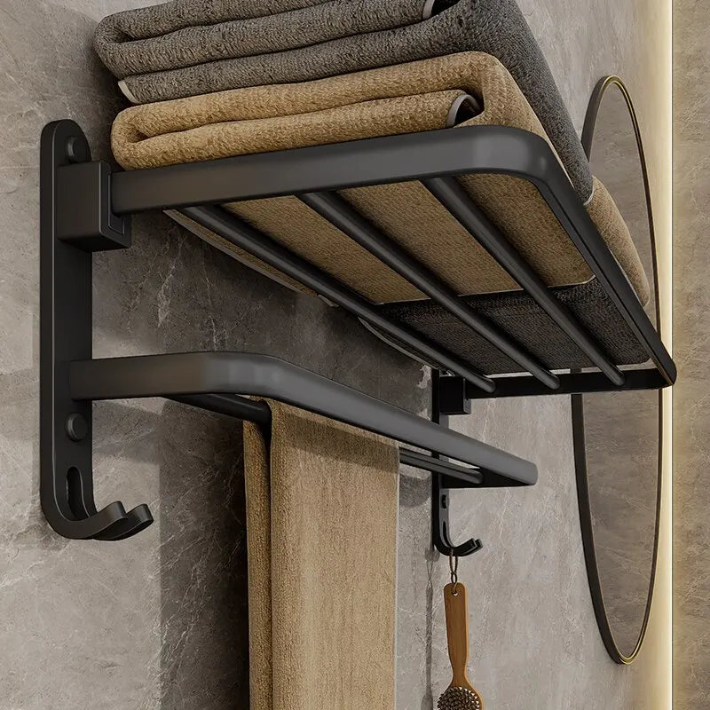 Black towel rack with folded towels on a bathroom wall
