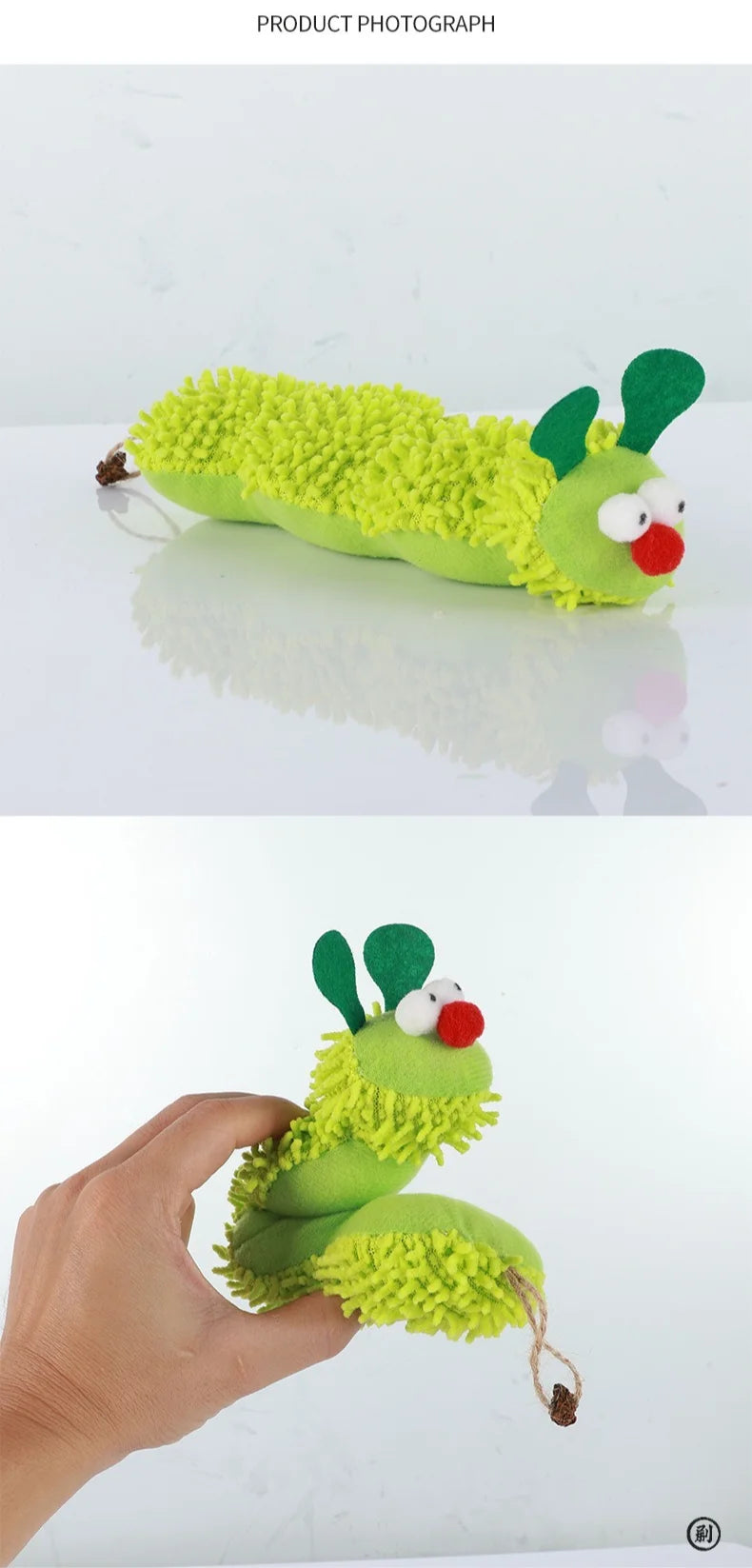 Green caterpillar-shaped toy with a hand holding it on a white background