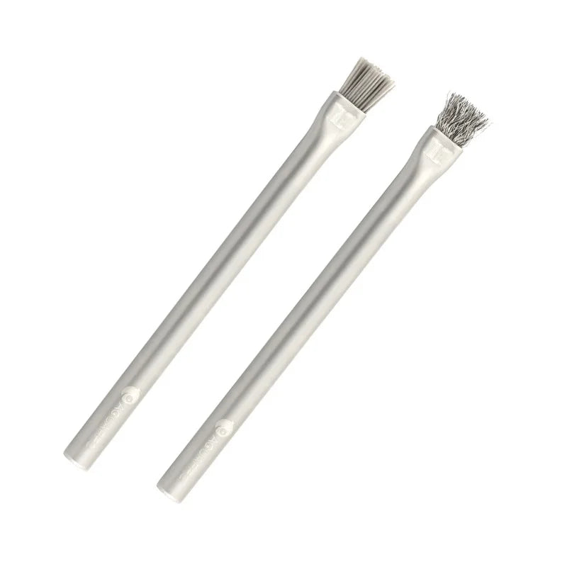 Two metal brushes with wire bristles on white background