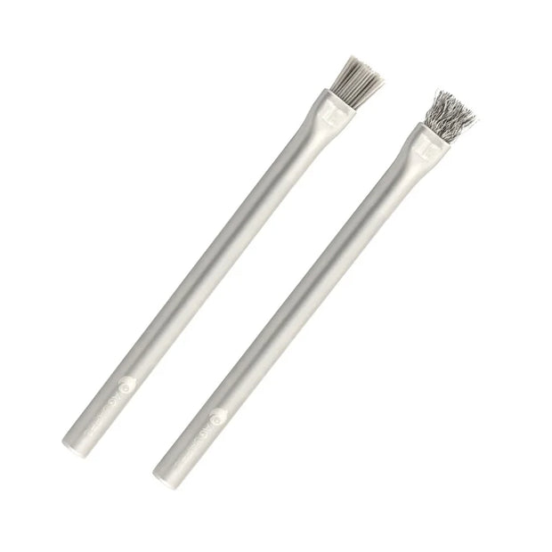 Two metal brushes with wire bristles on white background