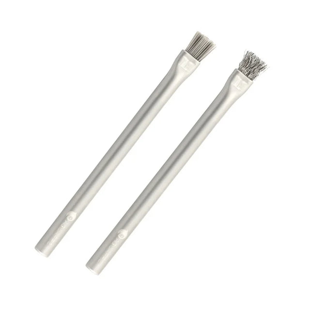 Two metal brushes with wire bristles on white background