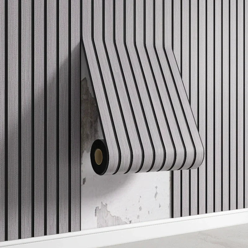 Roll of black and white striped fabric on a wooden surface