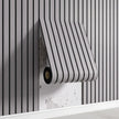 Roll of black and white striped fabric on a wooden surface