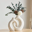 Decorative vase with floral arrangement on a wooden surface