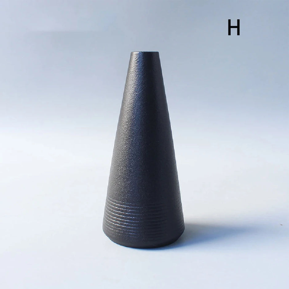 Black textured vase on a light gray background