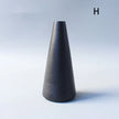 Black textured vase on a light gray background