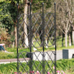Black metal trellis in a garden setting with blurred background
