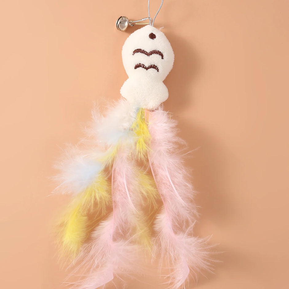 Plush ghost toy with feathered skirt on a peach background