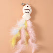 Plush ghost toy with feathered skirt on a peach background