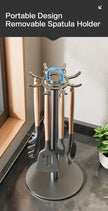 Portable spatula holder with multiple spatulas on a kitchen counter.