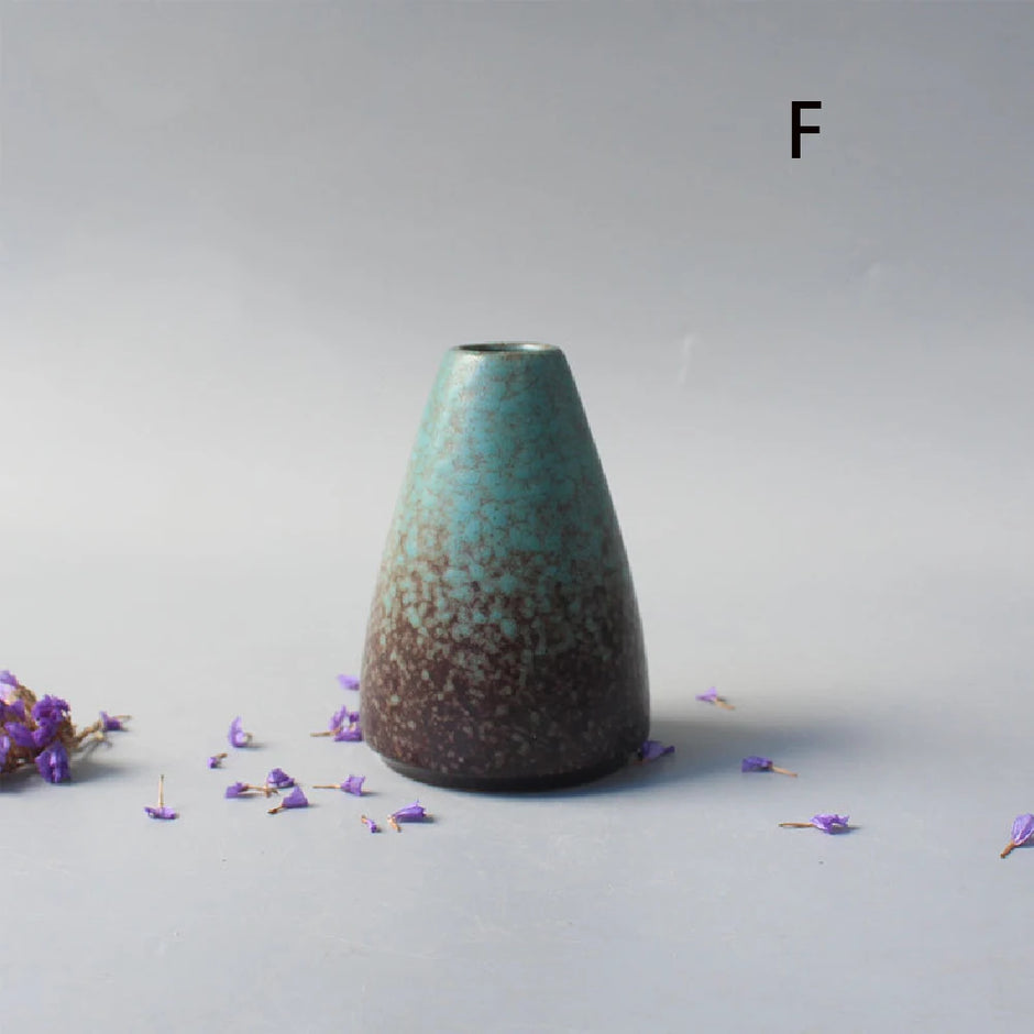 Tapered ceramic vase with a textured surface on a light gray background