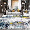 Modern living room with a patterned rug, sofa, and decorative pillows.