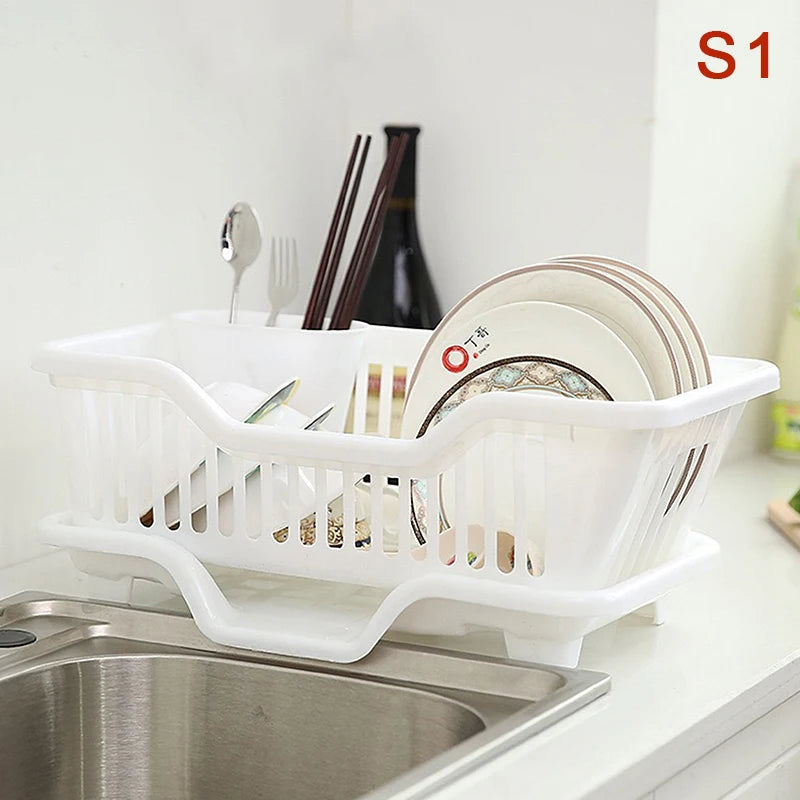 White dish rack with dishes on a kitchen counter next to a sink