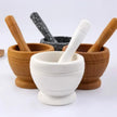 Set of mortar and pestle with different materials on a white background