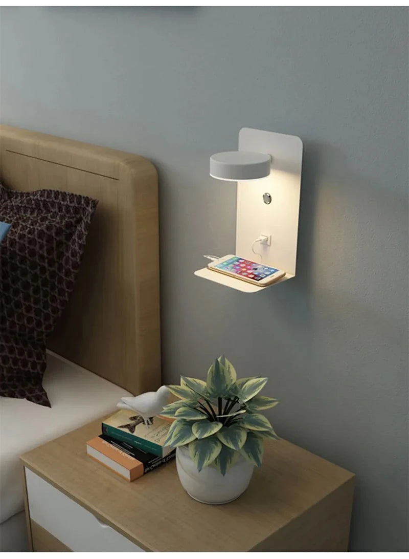 Wall-mounted night light with a shelf above a bedside table in a bedroom setting.