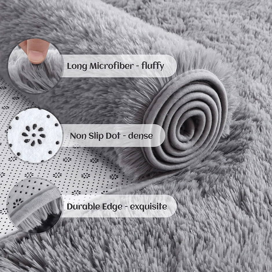 Gray rug with text labels highlighting features like 'Ultra Soft', 'Anti-Slip Points', and 'Frosted Edges'.