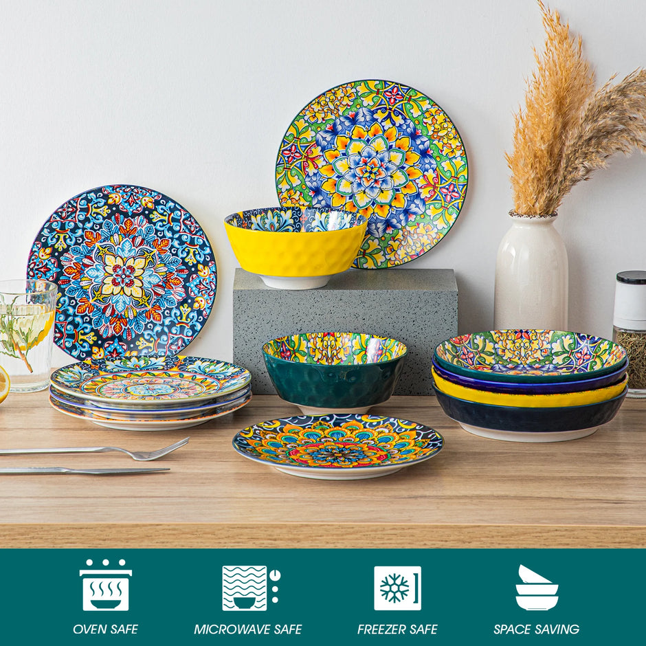 Colorful ceramic dinnerware set on a wooden surface with decorative elements.