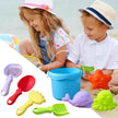 Children playing with colorful sand toys on a beach, including a bucket and various tools.