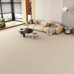 Modern living room with a beige sectional sofa and light gray carpet.