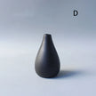 Black ceramic vase on a light gray background