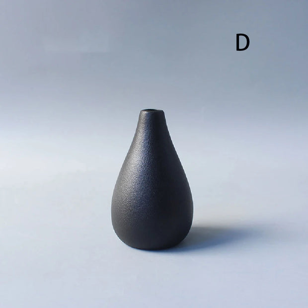 Black ceramic vase on a light gray background