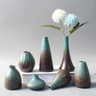 Set of ceramic vases with a gradient finish on a gray background
