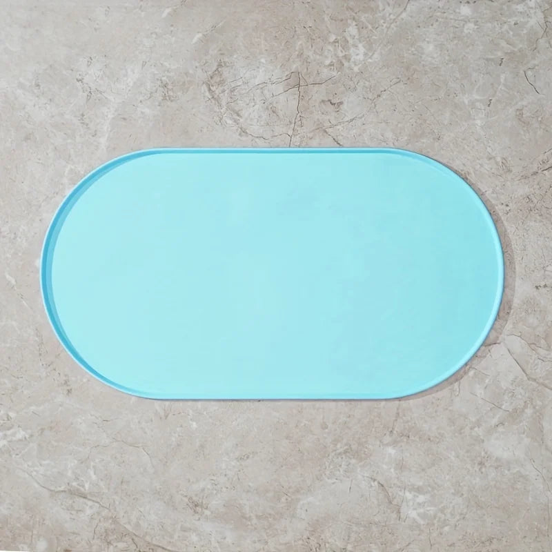 Light blue bath mat on a beige tiled floor