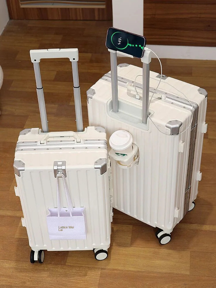 Two white suitcases on a wooden floor with a smartphone on top.