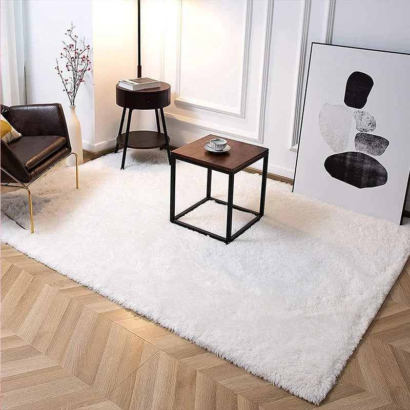 Modern living room with a white rug, wooden coffee table, and decorative elements.