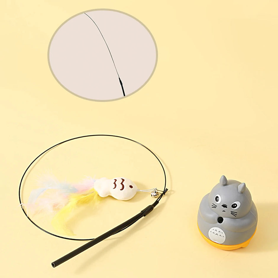 Cat-shaped toy with a string on a yellow background
