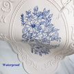 Decorative plate with blue floral design and water droplets on a white background