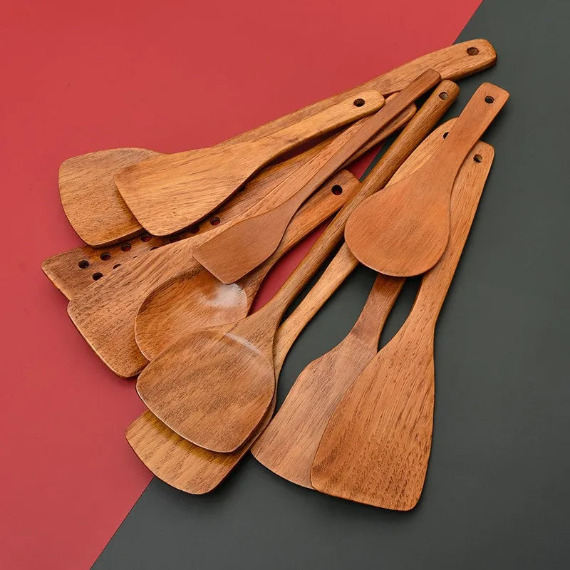 Set of wooden cooking utensils on a two-tone red and gray background