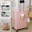 Pink suitcase with cup holder and charging port, next to product packaging.