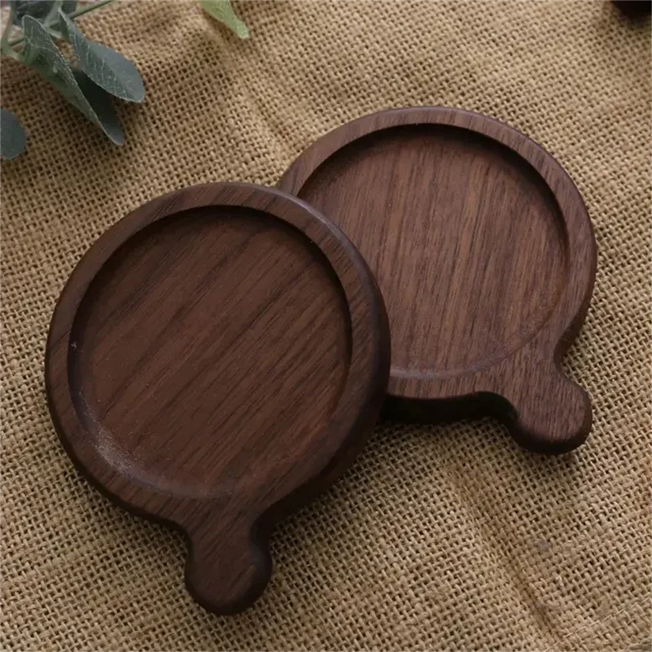 Two wooden coasters on a textured fabric background
