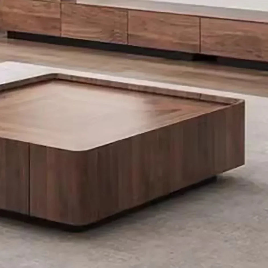 Wooden coffee table with a minimalist design on a concrete floor.