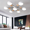 Modern chandelier in a living room with a couch and artwork on the wall.