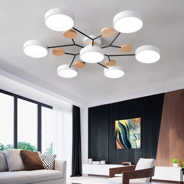 Modern chandelier in a living room with a couch and artwork on the wall.