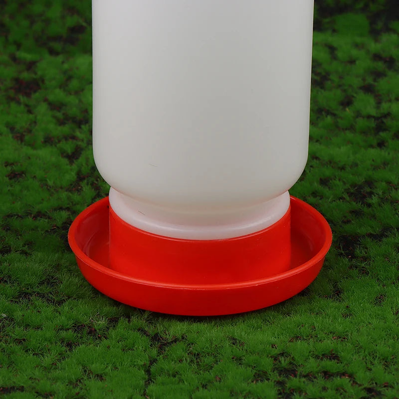 White plastic bottle with a red base on a green grass background