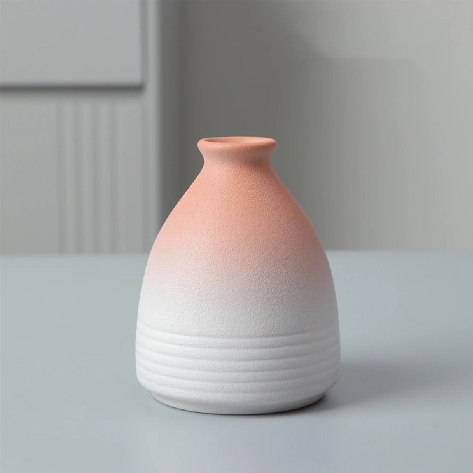 Ceramic vase with gradient color from pink to white on a neutral background