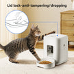 Cat interacting with a white pet feeder with lid lock feature, on a light wooden floor.