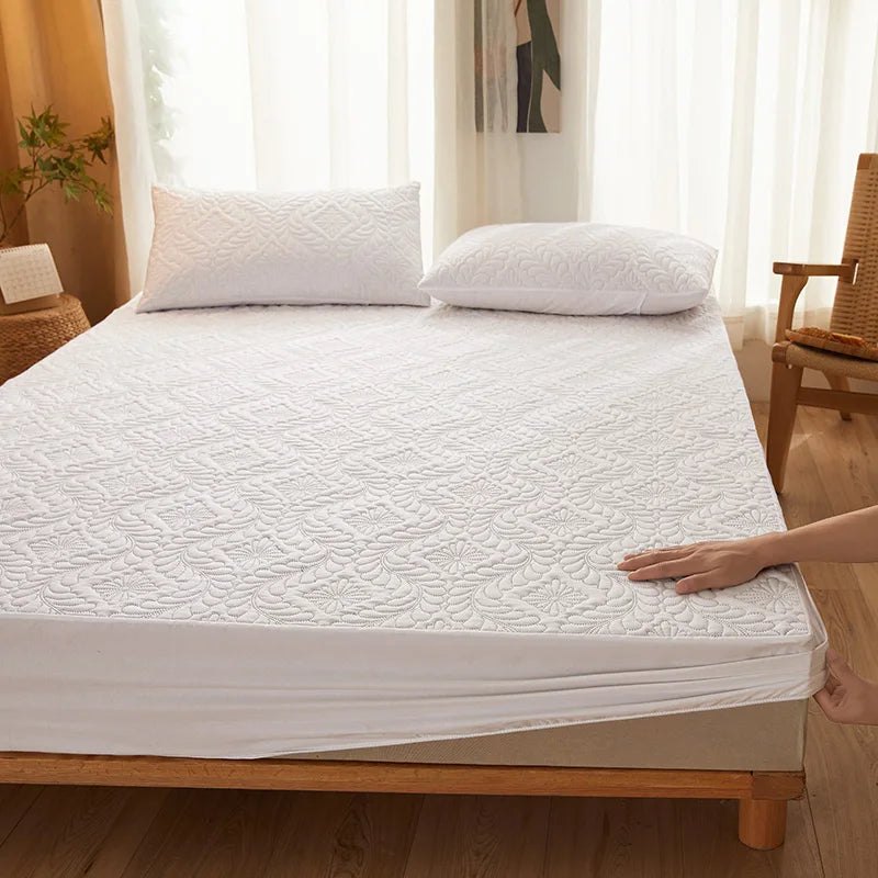 White mattress cover on a bed in a bedroom setting