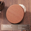 Round wooden coaster on a wooden surface with text overlay.