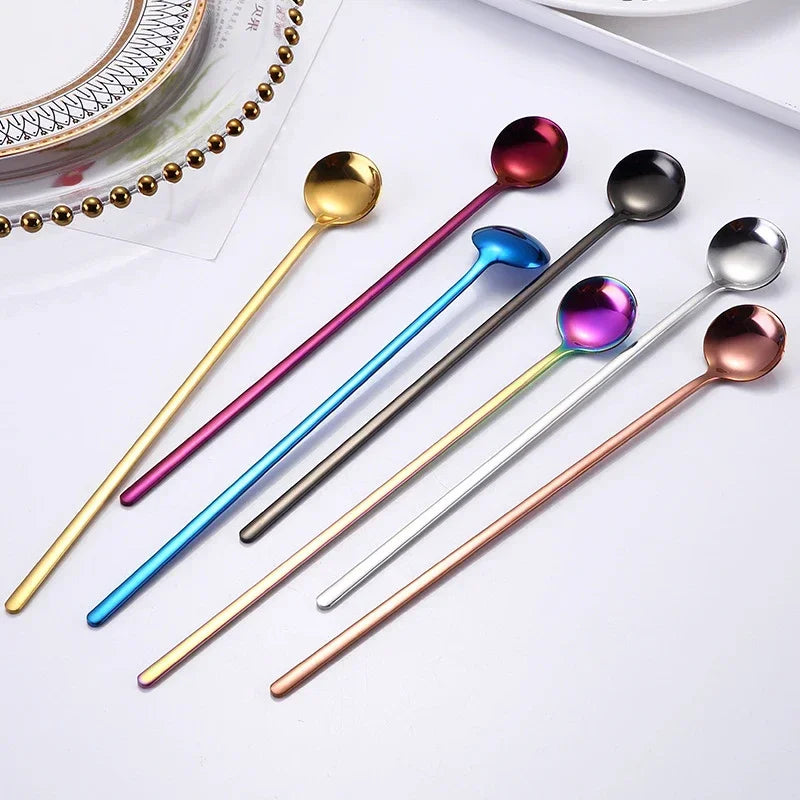 Set of colorful spoons on a white surface