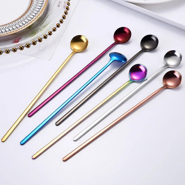 Set of colorful spoons on a white surface