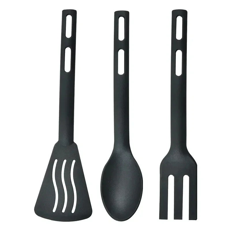 Set of three black kitchen utensils on a white background